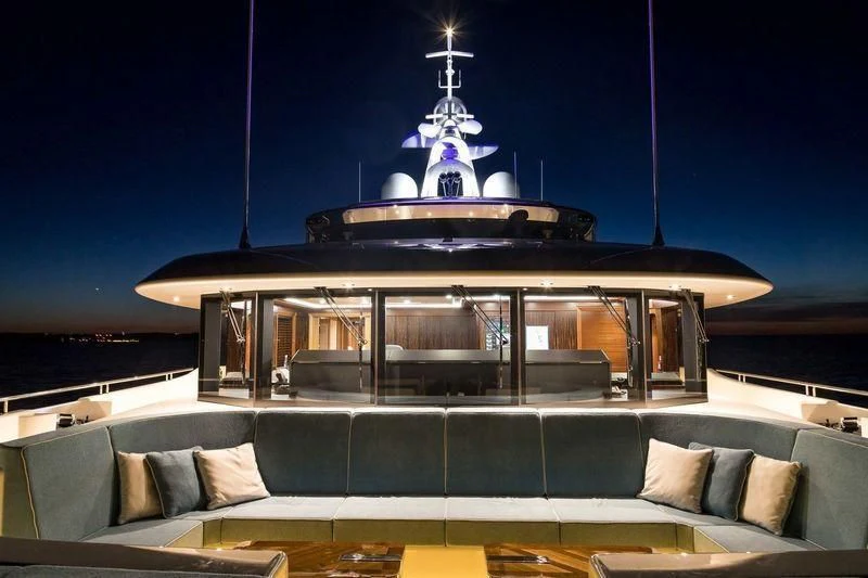a large room with a couch and a large chandelier aboard VIATORIS Yacht for Sale