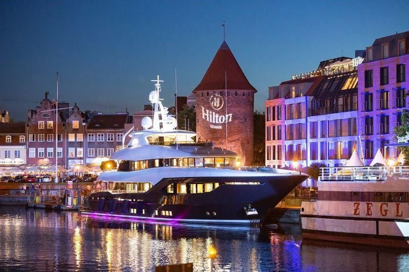a large boat in a harbor aboard VIATORIS Yacht for Sale