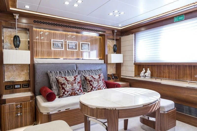 a room with a couch and a table aboard VIATORIS Yacht for Sale