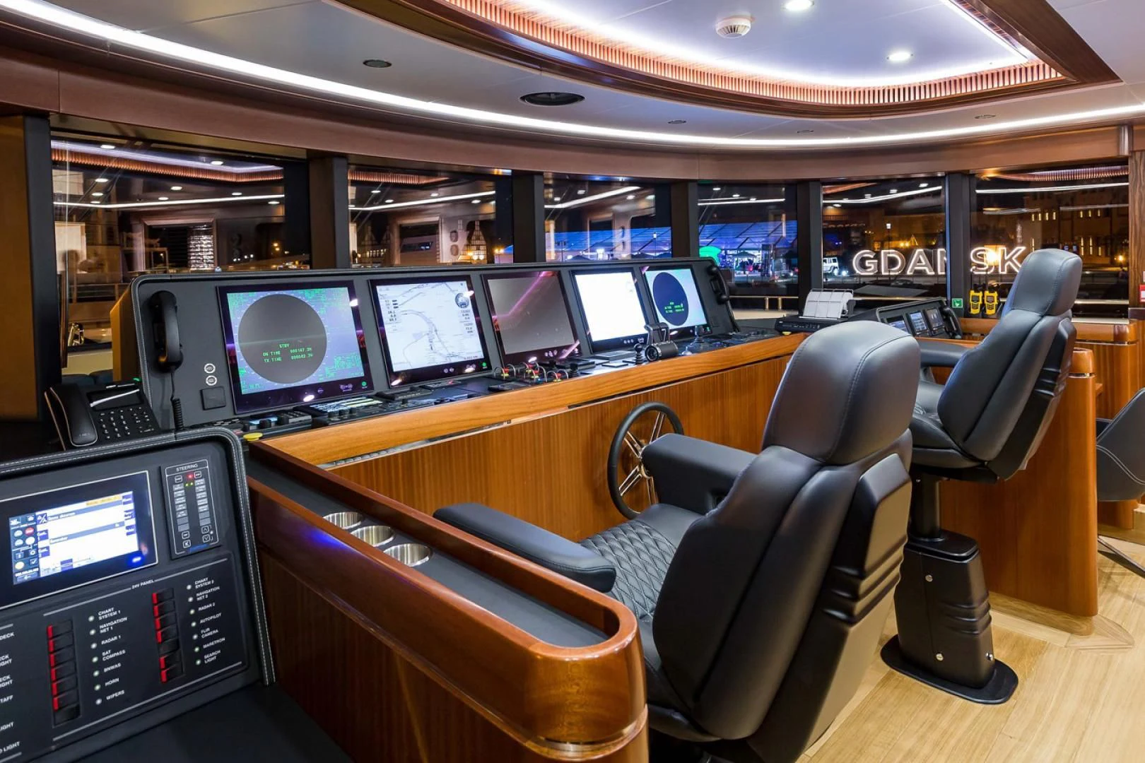 a room with many monitors and chairs aboard VIATORIS Yacht for Sale