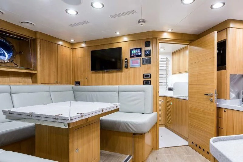a living room with a couch and a television aboard VIATORIS Yacht for Sale