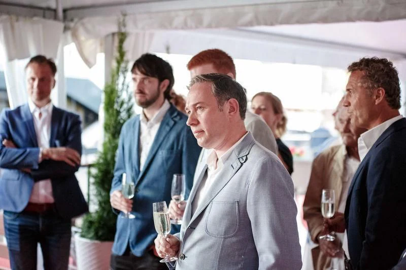 a group of men talking aboard VIATORIS Yacht for Sale