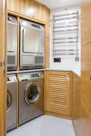 a kitchen with a washer and dryer aboard VIATORIS Yacht for Sale