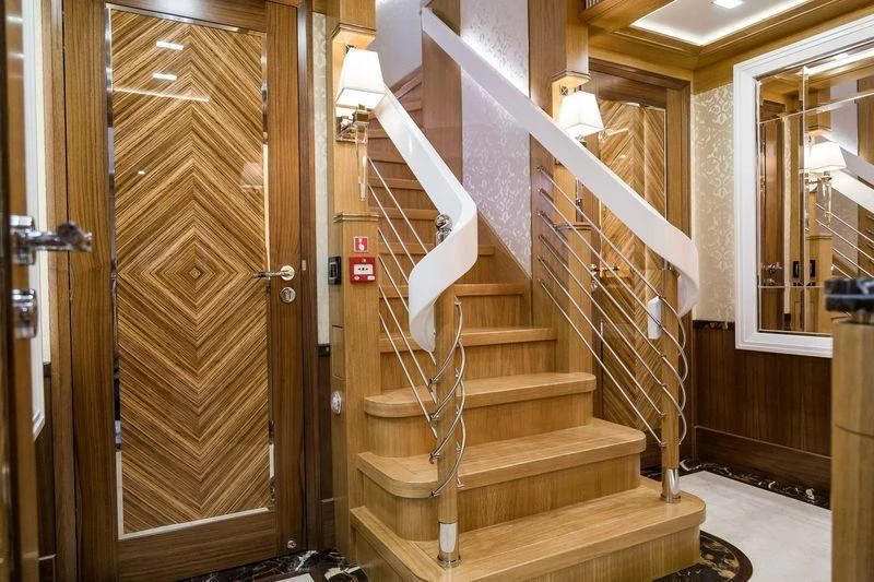 a wooden staircase in a house aboard VIATORIS Yacht for Sale