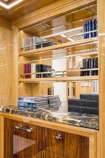 a shelf with books and a computer aboard VIATORIS Yacht for Sale