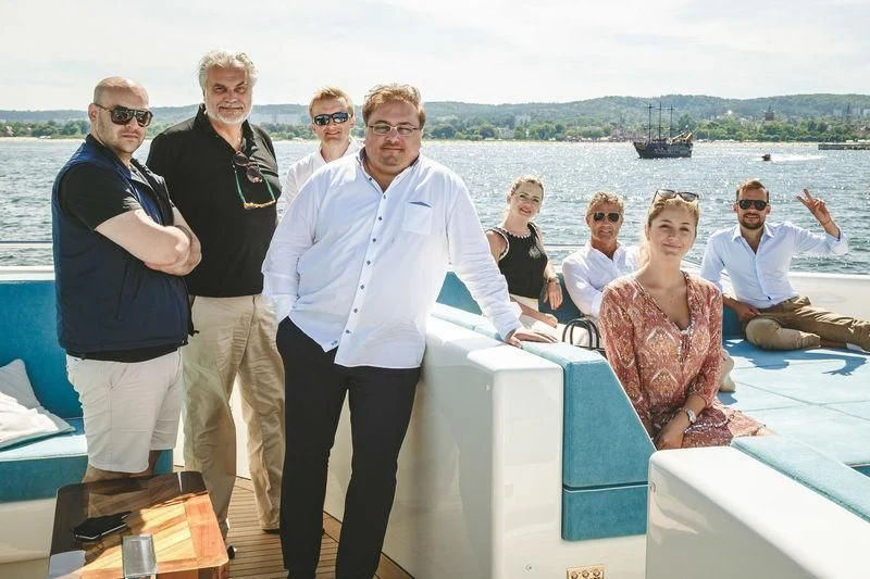 a group of people posing for a photo on a boat aboard VIATORIS Yacht for Sale