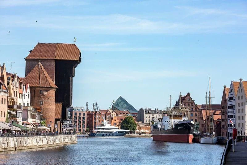 a city with boats and buildings aboard VIATORIS Yacht for Sale