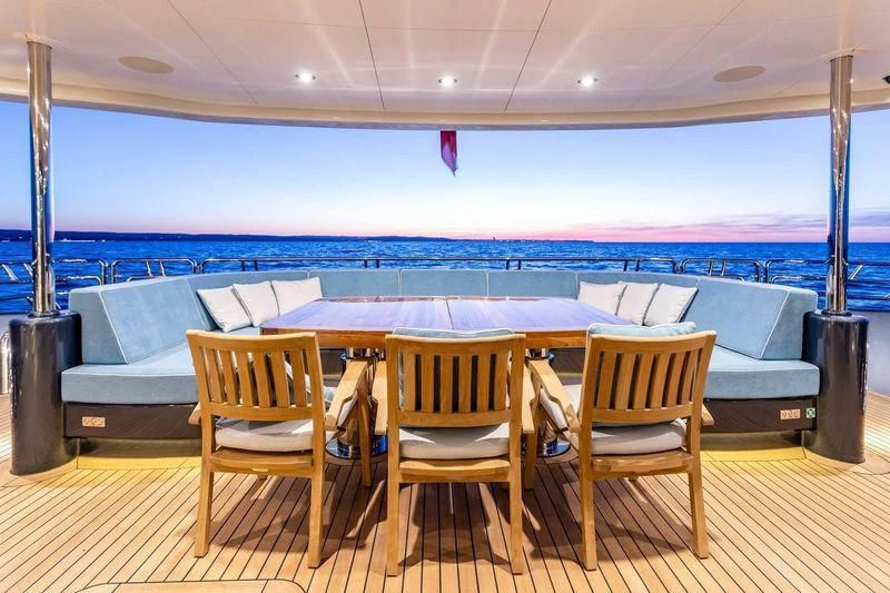 a table and chairs on a deck aboard VIATORIS Yacht for Sale
