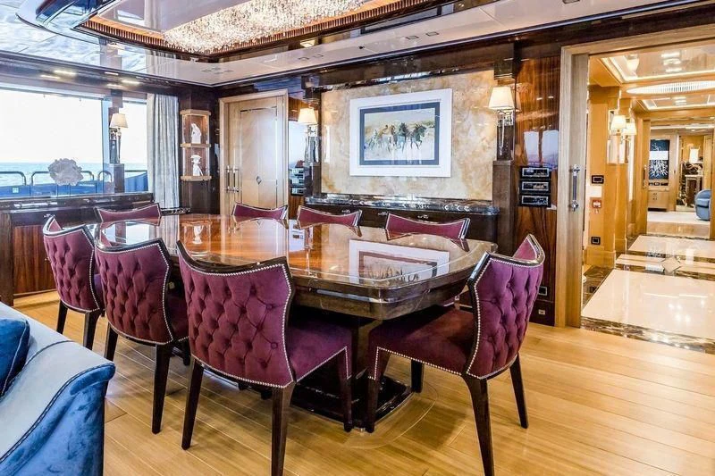 a dining room with chairs and a table aboard VIATORIS Yacht for Sale