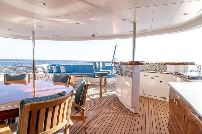 a boat with a table and chairs aboard VIATORIS Yacht for Sale