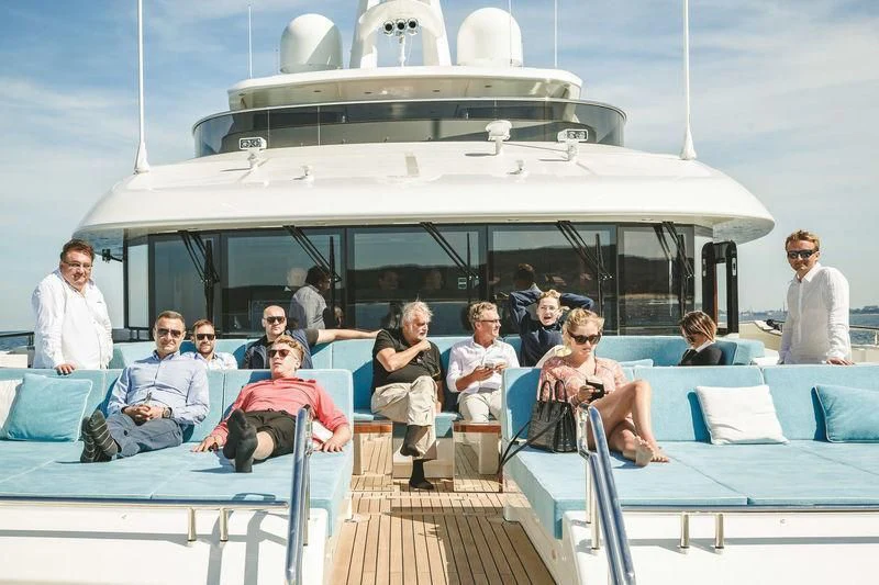 a group of people sitting on a boat aboard VIATORIS Yacht for Sale