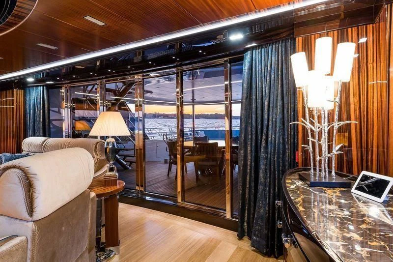 a living room with a large glass wall aboard VIATORIS Yacht for Sale