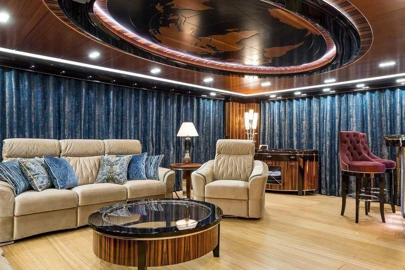 a living room with a couch and a table aboard VIATORIS Yacht for Sale
