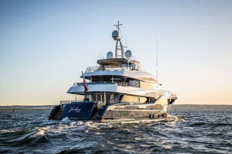 a boat in the water with Thomas Point Shoal Light in the background aboard VIATORIS Yacht for Sale
