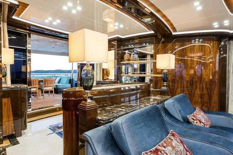 a living room with a blue couch aboard VIATORIS Yacht for Sale