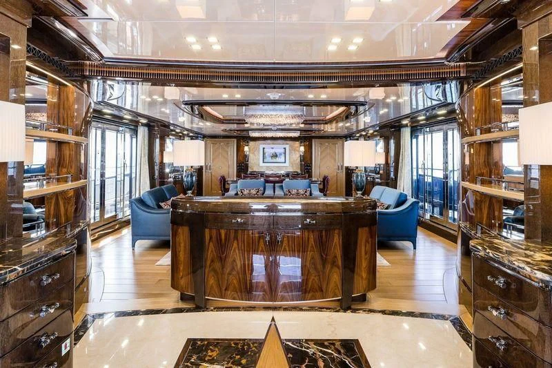 a large room with a table and chairs aboard VIATORIS Yacht for Sale