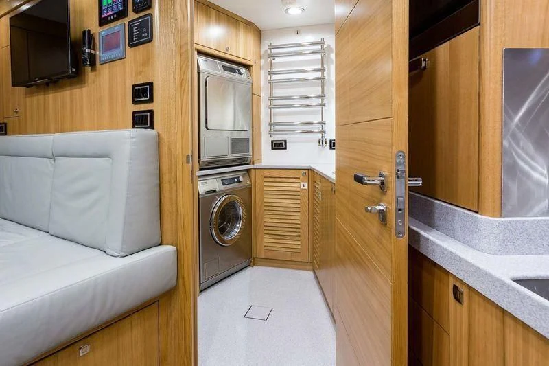 a room with a bed and a couch aboard VIATORIS Yacht for Sale
