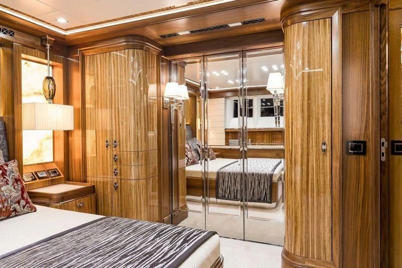 a bedroom with a bed and a closet aboard VIATORIS Yacht for Sale