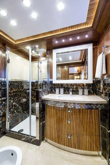a bathroom with a glass shower aboard VIATORIS Yacht for Sale