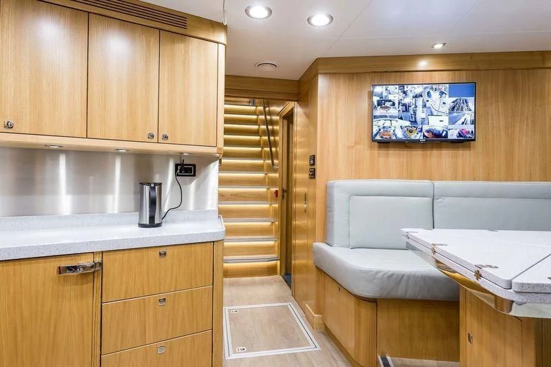 a room with a couch and a table aboard VIATORIS Yacht for Sale