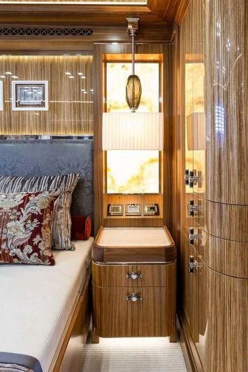 a room with a bed and a mirror aboard VIATORIS Yacht for Sale