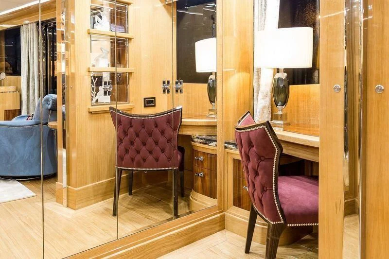 a room with a chair and a table aboard VIATORIS Yacht for Sale