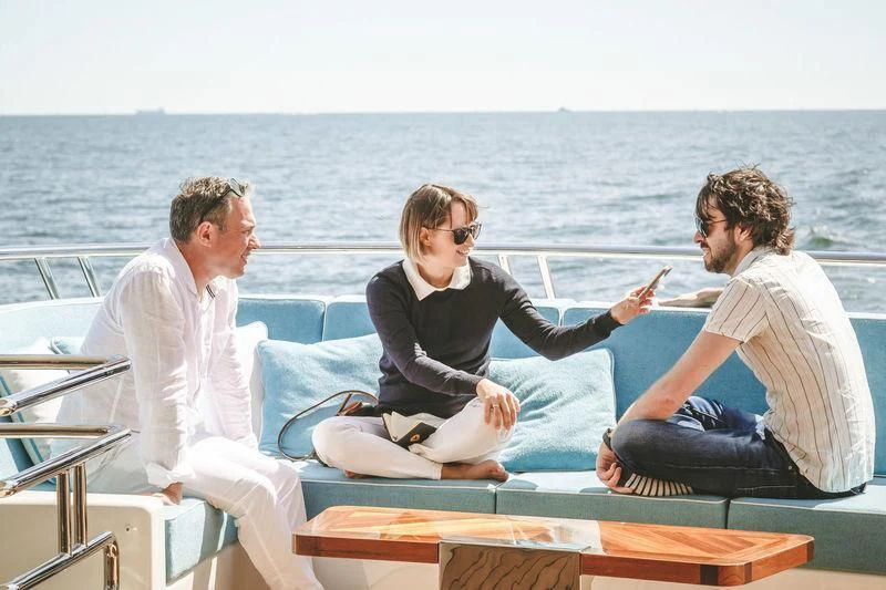 a group of people sitting on a boat aboard VIATORIS Yacht for Sale