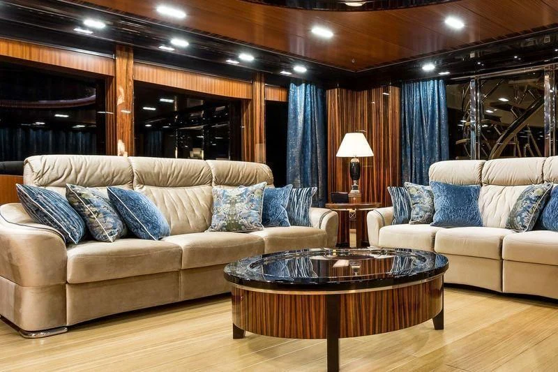 a living room with a couch and a coffee table aboard VIATORIS Yacht for Sale