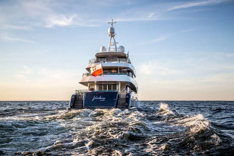 a boat in the water with Thomas Point Shoal Light in the background aboard VIATORIS Yacht for Sale
