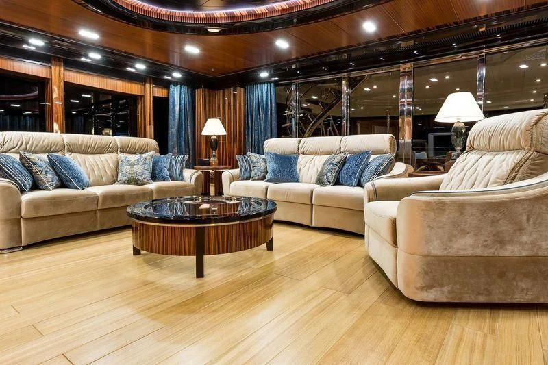 a living room with a couch and a table aboard VIATORIS Yacht for Sale