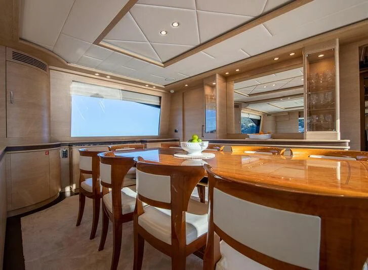 a kitchen with a table and chairs aboard GRACE Yacht for Sale