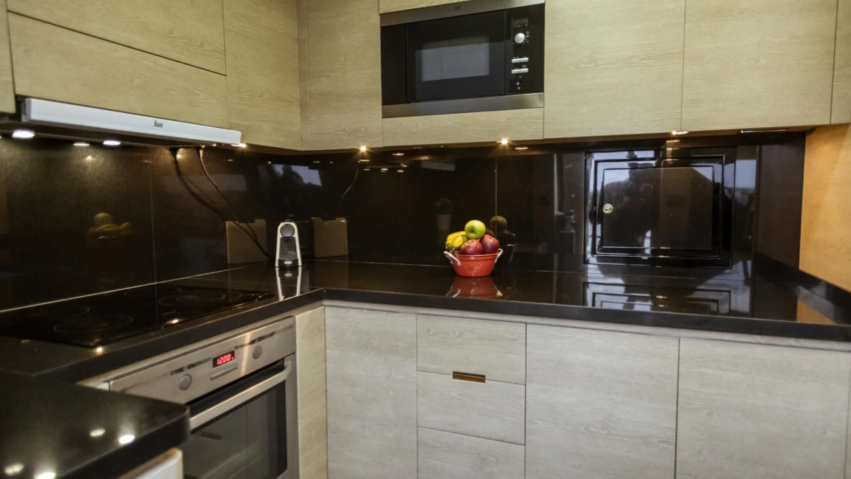 a kitchen with a black stove and microwave aboard GRACE Yacht for Sale