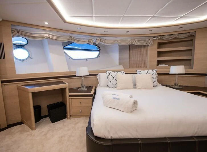 a room with a bed and a desk aboard GRACE Yacht for Sale