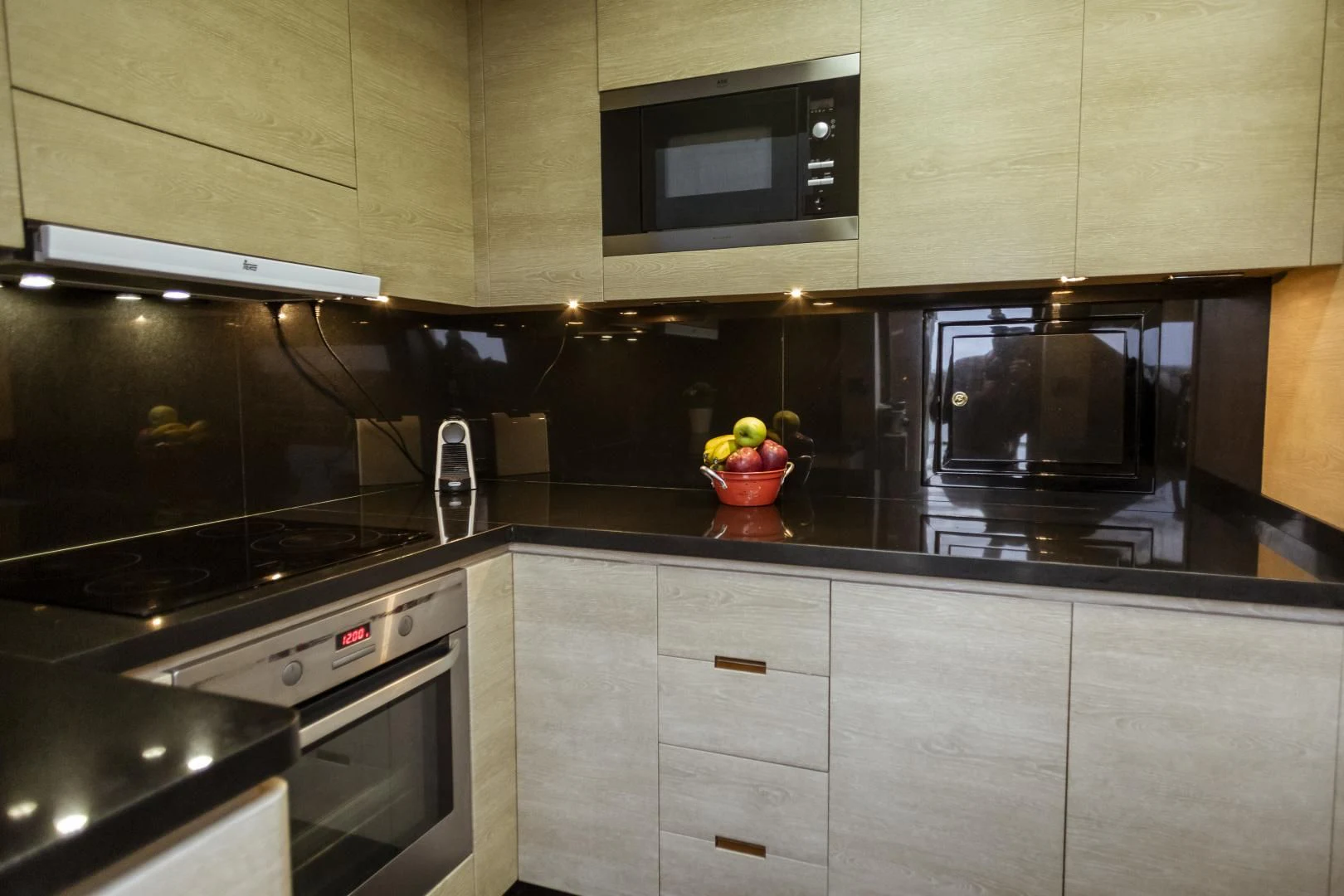 a kitchen with black appliances aboard GRACE Yacht for Sale