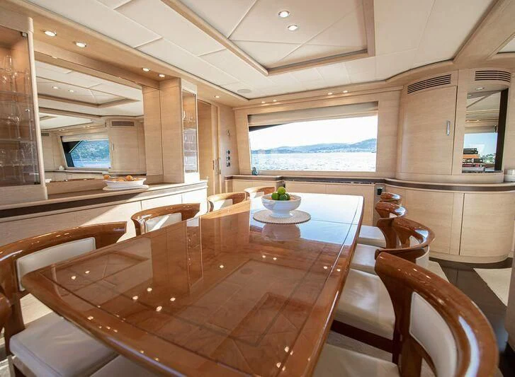a room with a table and chairs aboard GRACE Yacht for Sale