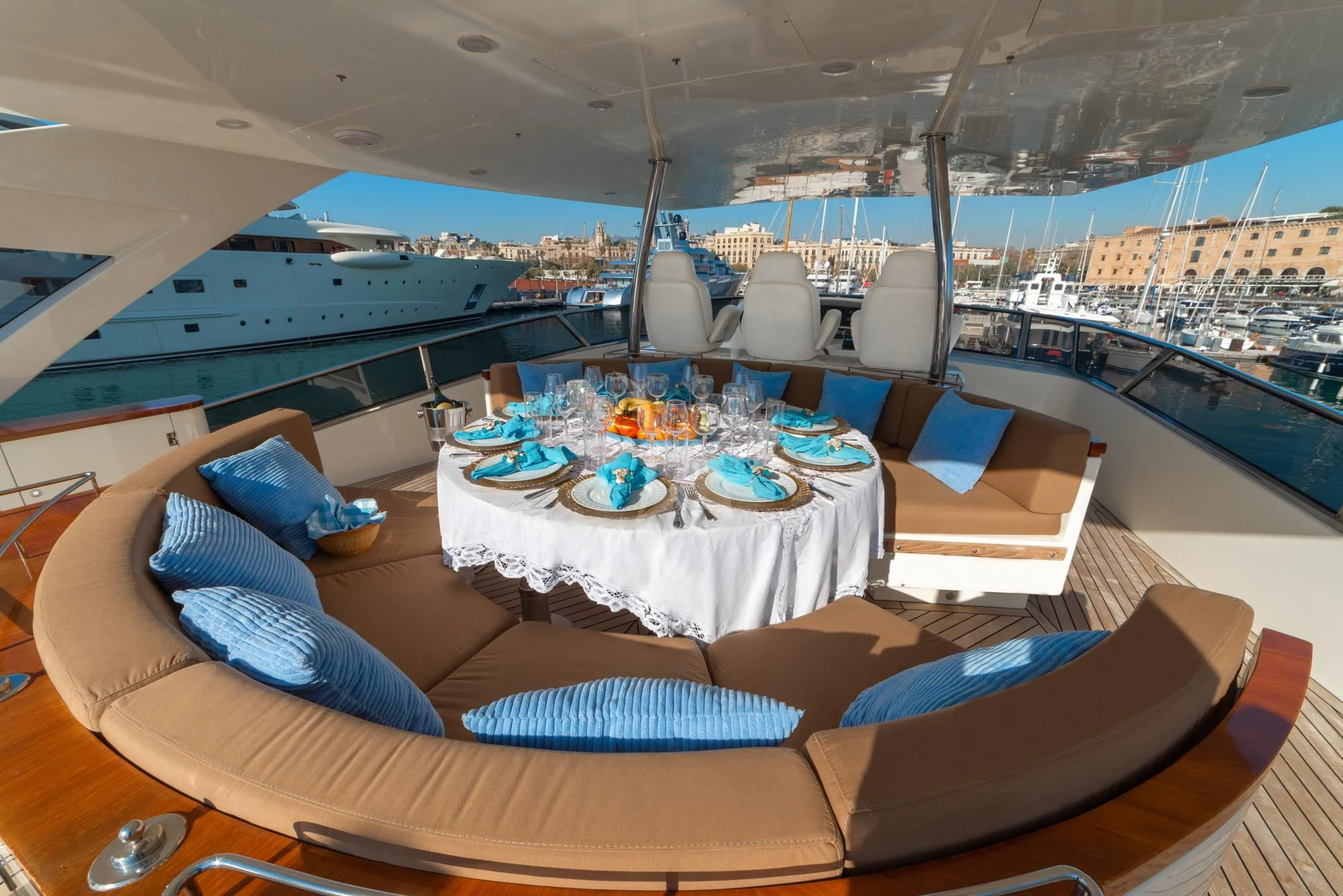 a large dining table with a large white table and chairs on a balcony aboard GRACE Yacht for Sale