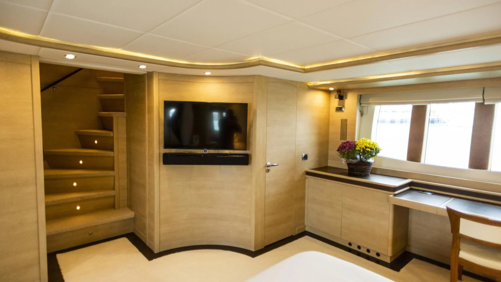 a room with a tv and a table aboard GRACE Yacht for Sale