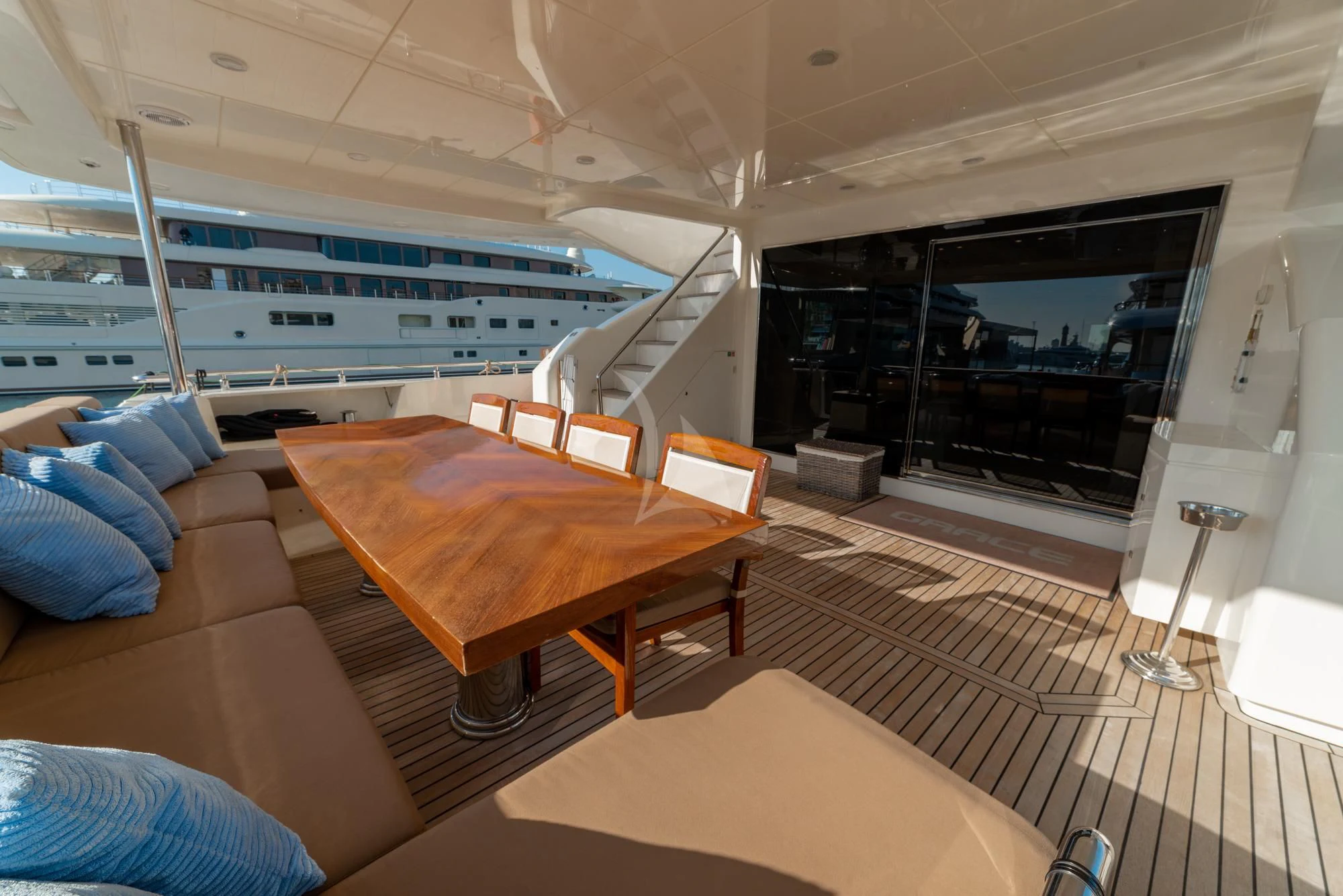 a boat with a table and chairs aboard GRACE Yacht for Sale