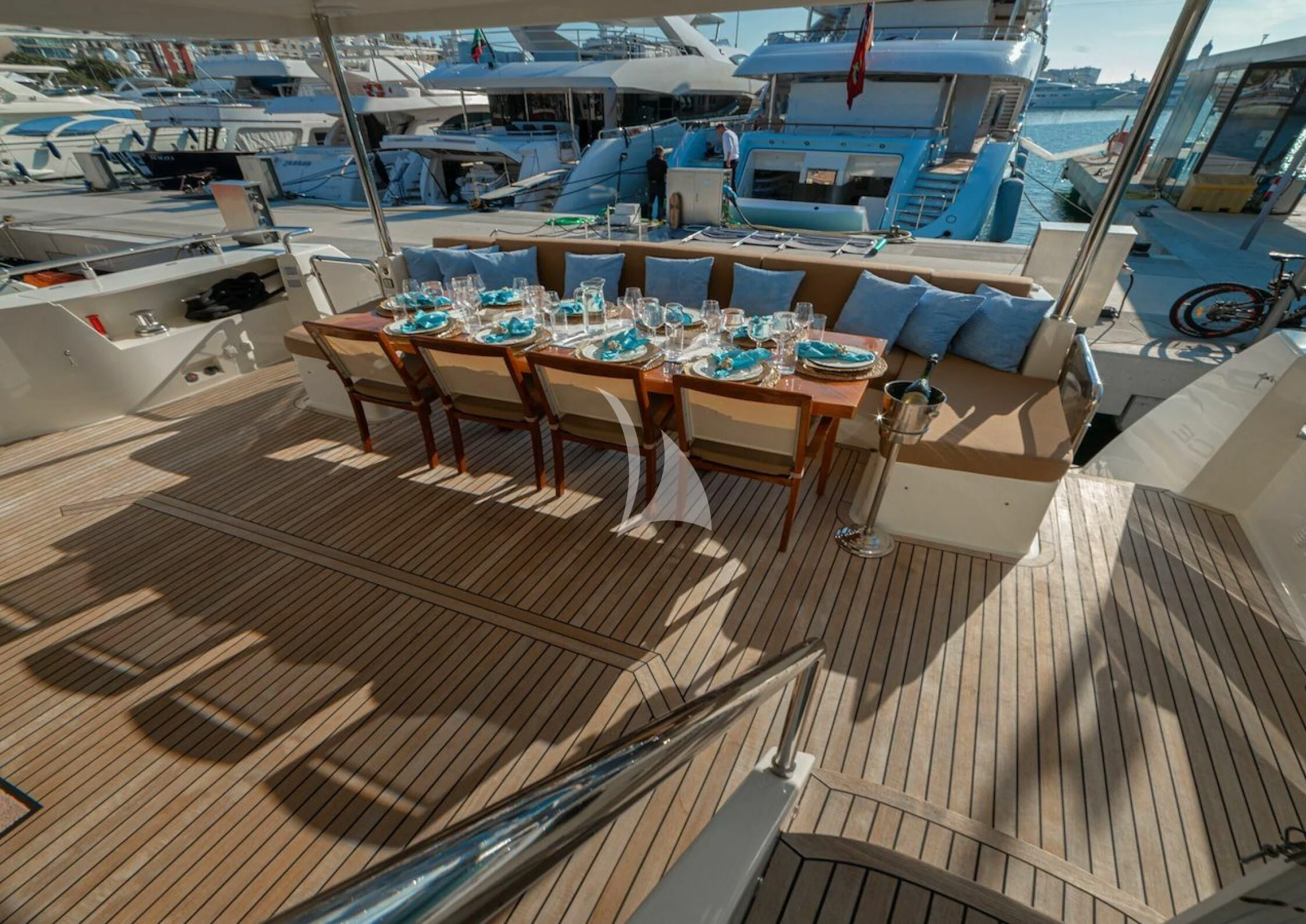 a boat deck with tables and chairs aboard GRACE Yacht for Sale