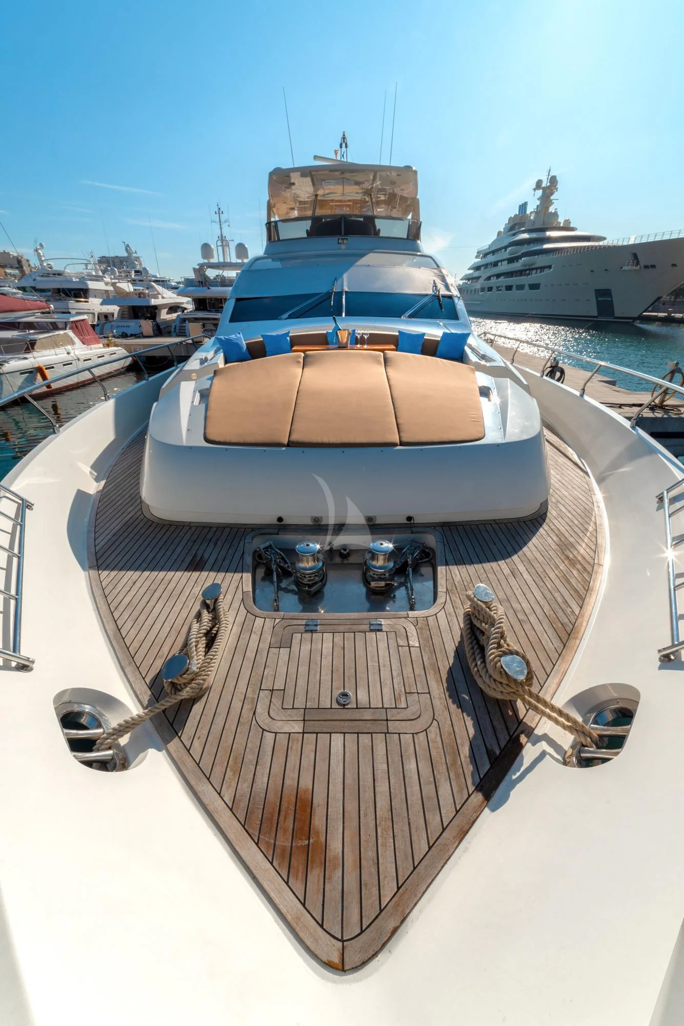 a boat with a large ship in the background with Forbidden City in the background aboard GRACE Yacht for Sale