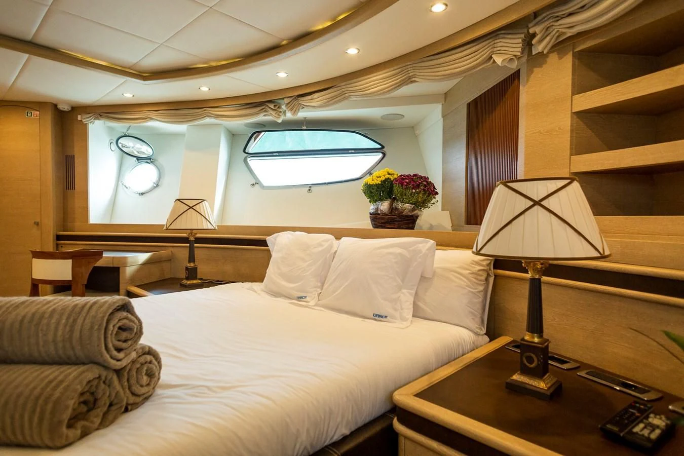 a bed with white sheets and pillows aboard GRACE Yacht for Sale