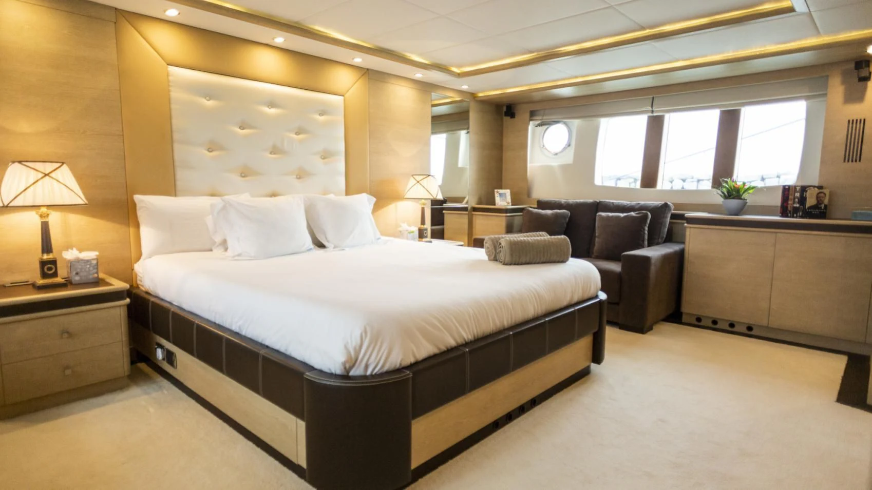 a large bedroom with a bed and a couch aboard GRACE Yacht for Sale