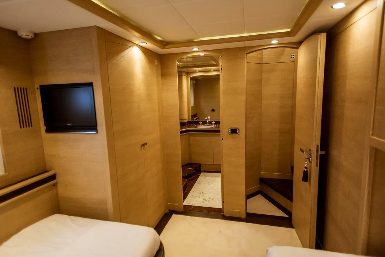 a hotel room with a bed and a tv aboard GRACE Yacht for Sale