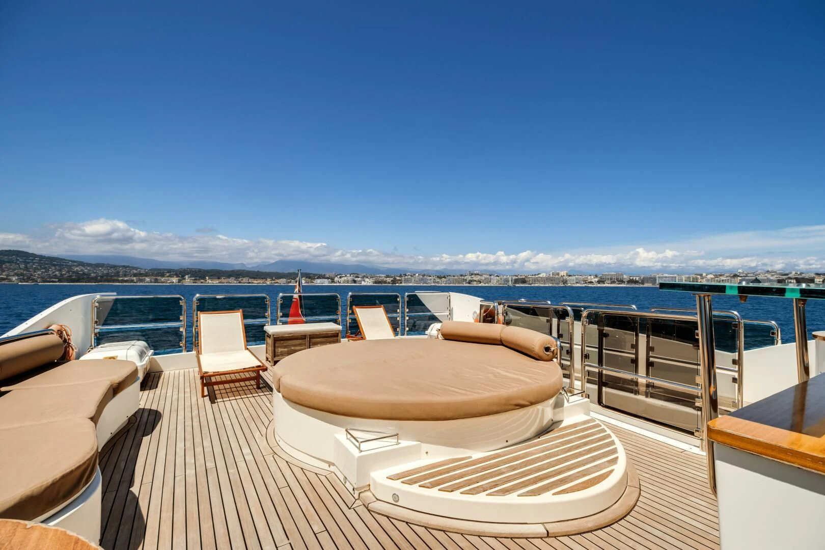 a deck with chairs and a body of water in the background aboard GRACE Yacht for Sale