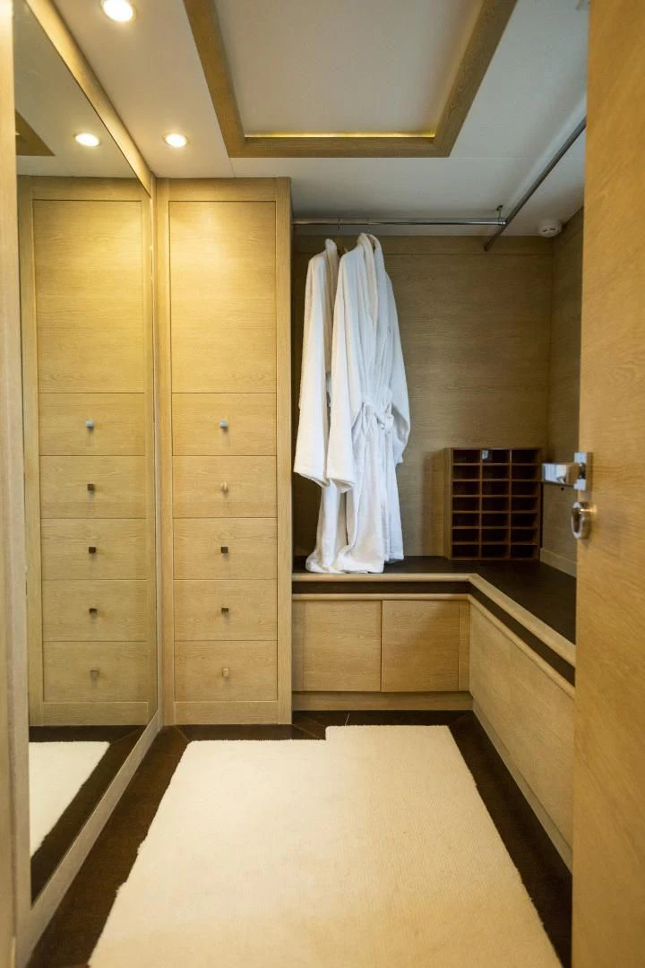 a bathroom with a large wooden closet aboard GRACE Yacht for Sale