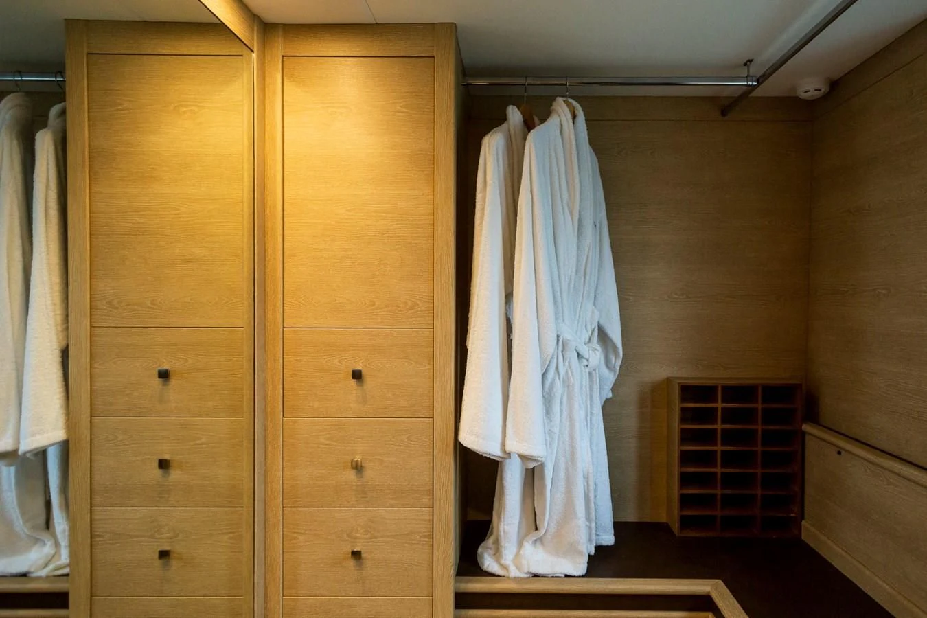a closet with clothes on the wall aboard GRACE Yacht for Sale