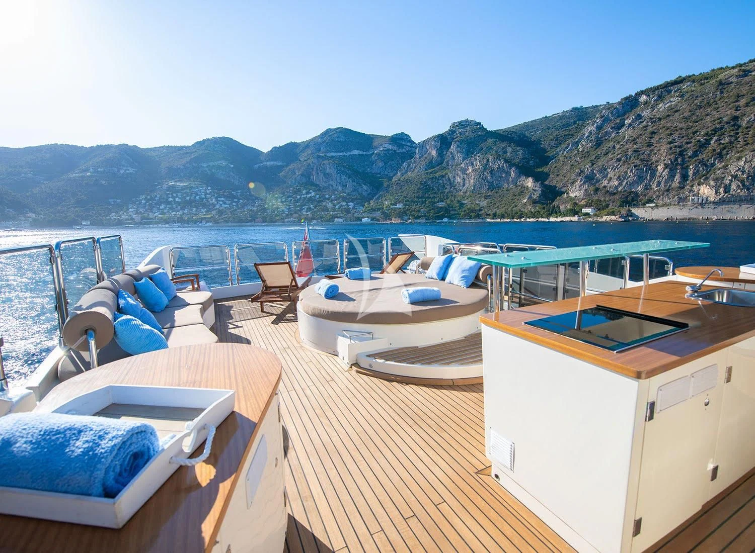 a deck with a view of a mountain and water aboard GRACE Yacht for Sale