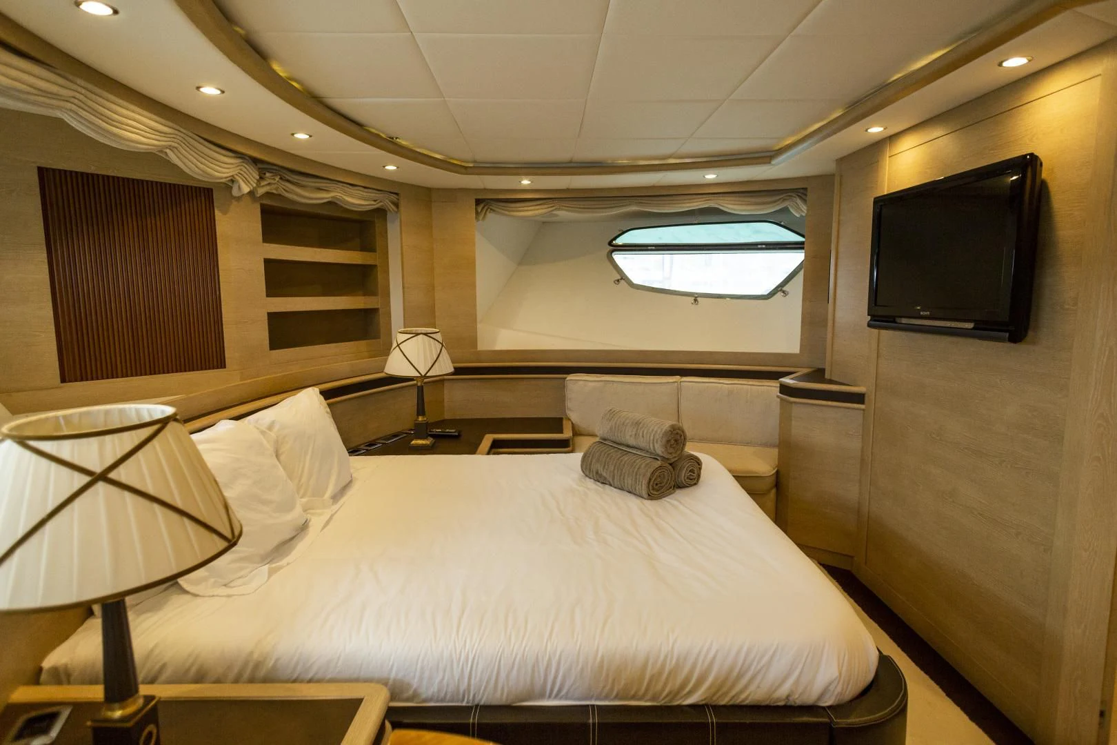 a hotel room with a bed and a television aboard GRACE Yacht for Sale