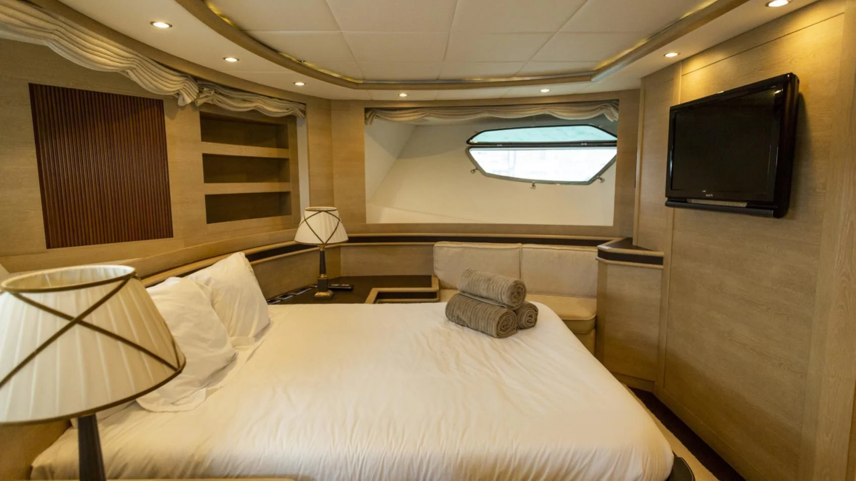a hotel room with a bed and a television aboard GRACE Yacht for Sale