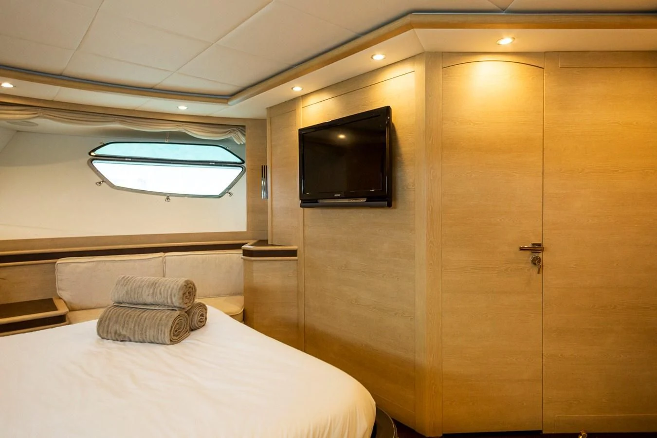 a room with a bed and a tv aboard GRACE Yacht for Sale